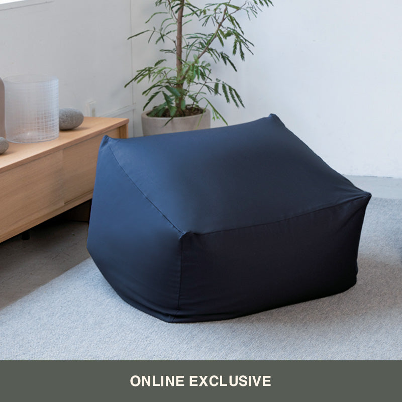 Navy Body Fit Cushion on living room floor. 