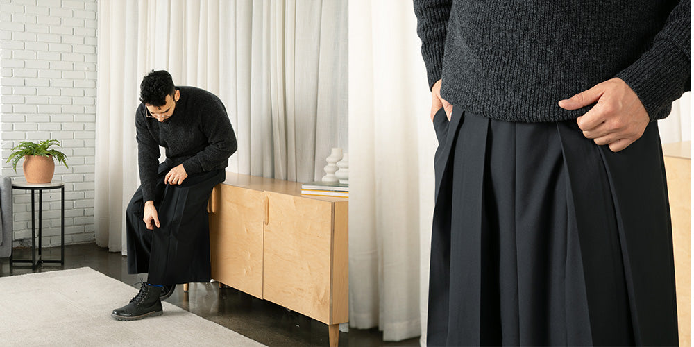 Person wearing a dark gray sweater and hakama pants.