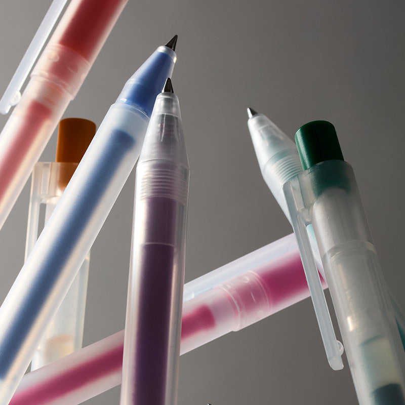 Close-up group of translucent gel pens in assorted colors, including pink, blue, purple, green, and orange.