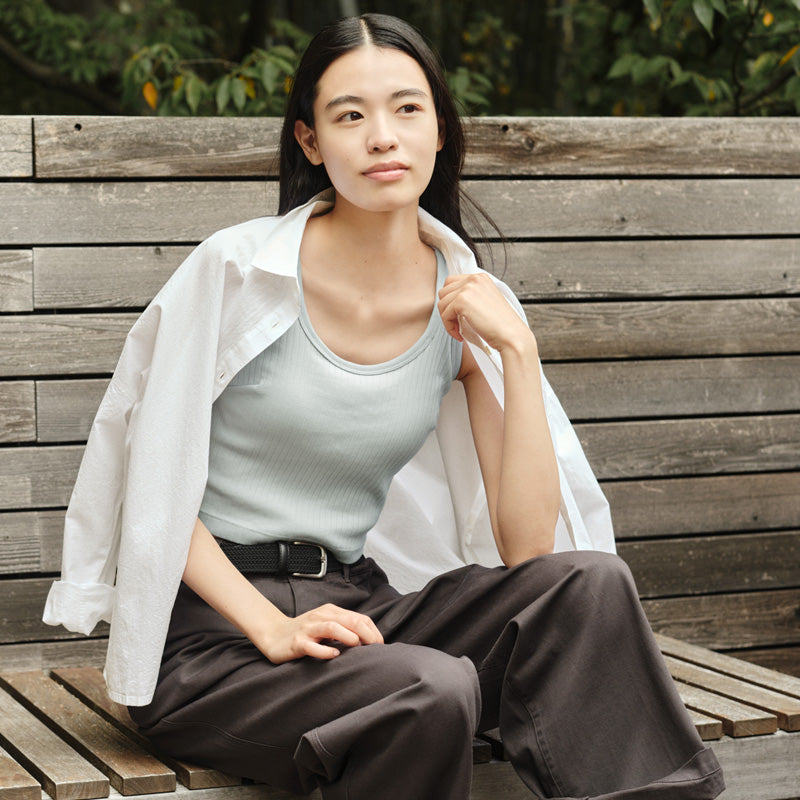 Woman wearing yellow stand collar shirt.