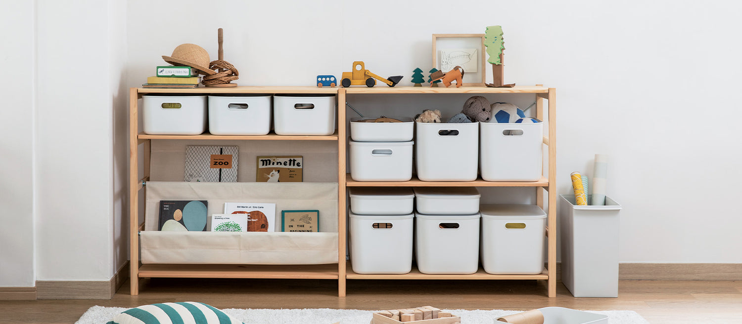Storage containers on a shelf in a child's playroom. 