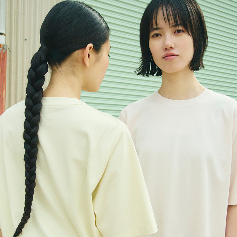 2 women wearing pastel colored t-shirts